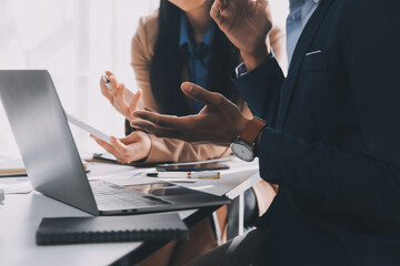 Business team working with new startup project plan and discussion information for financial strategy with laptop and digital tablet in a modern business lounge.