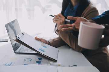 Business team working with new startup project plan and discussion information for financial strategy with laptop and digital tablet in a modern business lounge.