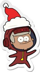 happy astronaut sticker cartoon of a wearing santa hat