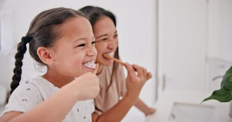 Mother, girl child and brushing teeth in bathroom, health and dental for fresh breathe, bonding and morning routine. People at home, cleaning mouth with toothpaste and toothbrush for oral hygiene - Powered by Adobe