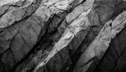 Black and white rock background symbolizing contrast and resilience. Distressed dark gray stone texture, close-up of mountain surface