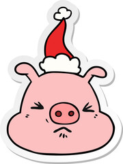 sticker cartoon of a angry pig face wearing santa hat