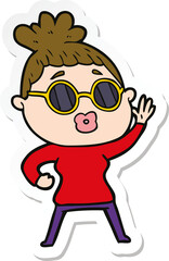 sticker of a cartoon waving woman wearing sunglasses