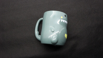 Plastic cups for children's drinking shaped like dinosaurs