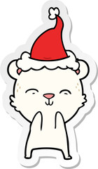 happy sticker cartoon of a polar bear wearing santa hat