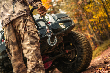 Driver Preparing Wrench Hook For the Car Recovery During Off Road Muddy Drive