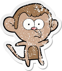 distressed sticker of a cartoon surprised monkey