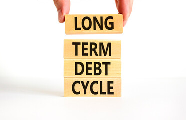 Long term debt cycle symbol. Concept words Long term debt cycle on beautiful wooden block. Beautiful white table white background. Businessman hand. Business Long term debt cycle concept. Copy space.