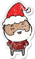 distressed sticker cartoon of a happy bearded man wearing santa hat