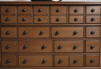 a wooden apothecary chest of drawers isolated on a transparent background