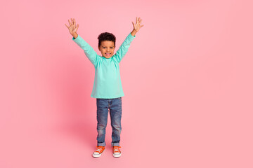 Full length photo of adorable little boy raise hands have fun dressed stylish cyan garment isolated on pink color background