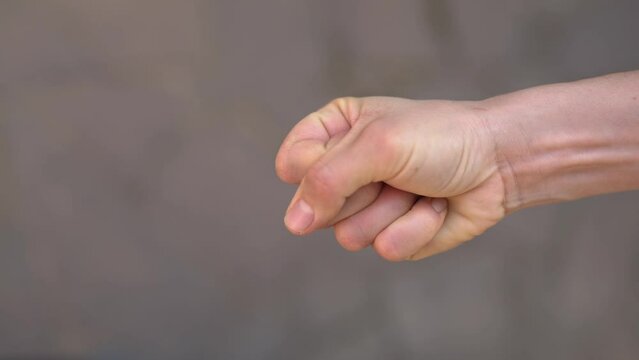 The palm crumples a $1 bill.