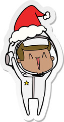 happy sticker cartoon of a astronaut wearing santa hat