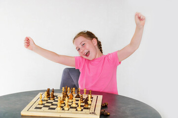 girl rejoicing from winning chess