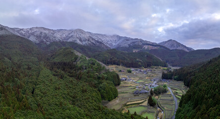 Terraced rice fields and snowy mountains in traditional Japanese village - 751552120