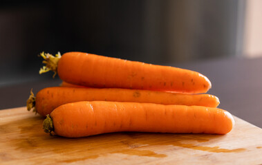 fresh carrots on wooden board close-up