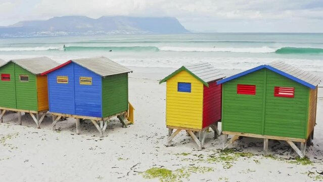 Surfing Paradise: Real-Time Video of People Surfing at Muizenberg Beach with Colorful Beach Huts, Cape Town, South Africa in 4K Ultra HD Resolution