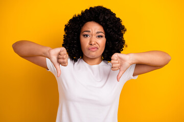 Photo of dissatisfied woman with perming coiffure dressed white t-shirt show thumb down dislike...
