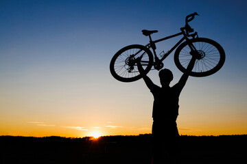 Cyclist silhouette with bicycle raised to sky race and victory concept