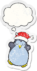 cute christmas penguin and thought bubble as a distressed worn sticker