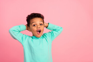 Photo portrait of adorable little boy touch head astonished shocked dressed stylish cyan garment...