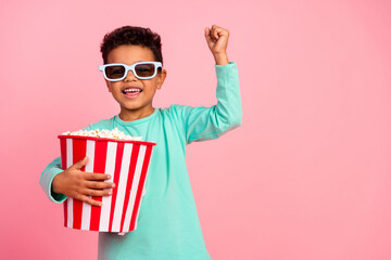 Photo portrait of cute little boy raise fist popcorn 3d glasses wear trendy aquamarine clothes...