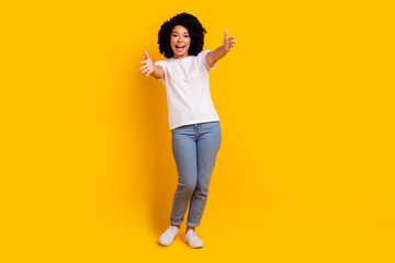 Full length photo of cheerful friendly lady dressed white t-shirt open arms ready hug you isolated yellow color background