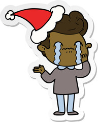 sticker cartoon of a man crying wearing santa hat