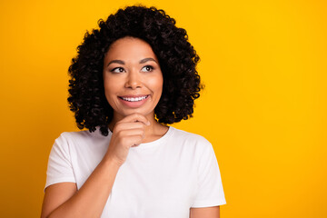 Fototapeta na wymiar Photo of dreamy woman with perming coiffure dressed white t-shirt look at dental ad empty space isolated on yellow color background