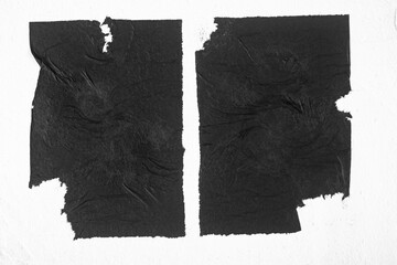 Two black posters with folds on a white background.
