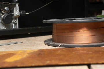 Spool of wire for semi-automatic welding machine MIG MAG. - obrazy, fototapety, plakaty