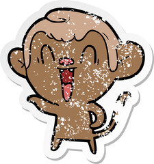 distressed sticker of a cartoon laughing monkey