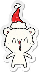 happy polar bear distressed sticker cartoon of a wearing santa hat