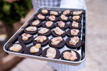 Waiter serving an appetizer, at an event in a restaurant,