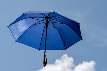 Blue umbrella. A sunny sky companion.
