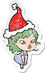 pretty distressed sticker cartoon of a elf girl wearing santa hat