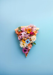 Pizza slice covered in spring flowers. Vegan diet, summertime flat lay background. - 751587711