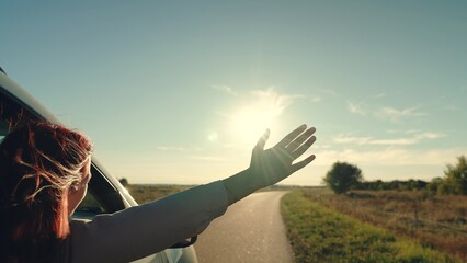 girl rides car with her hand out window, conceptual travel, cars summer day, adventure lifestyle,...