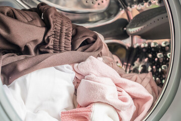 Washing machine loaded with clothes close up