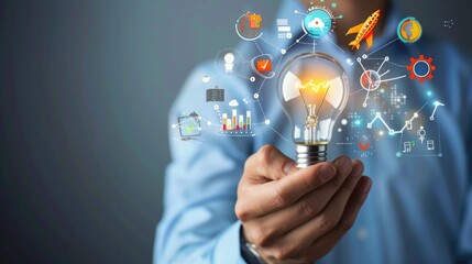 Businessman holding creative light bulb with growth graph and aerospace icons.