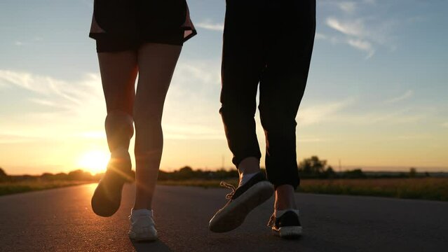 two friends running sunset, team group girls running sunset, silhouette athletic girls, teamwork american woman running along road, attractive asian woman, jogging exercise, motivation running with