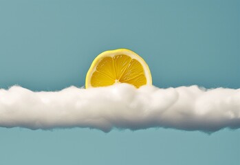 Sun presented as a lemon slice behind a strip of cotton clouds. Sunny, summertime conceptual background. - 751593591