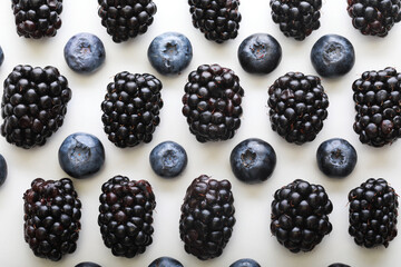 Mix berries patern over white background. Blackberries and blueberries.