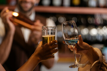 Man bartender is making a drink and dancing at bar. Dance party with group people dancing . Women...
