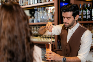 Man bartender is making a drink and dancing at bar. Dance party with group people dancing . Women and men have fun and drinking martini cocktail in night club.