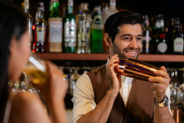 Man bartender is making a drink and dancing at bar. Dance party with group people dancing . Women and men have fun and drinking martini cocktail in night club.