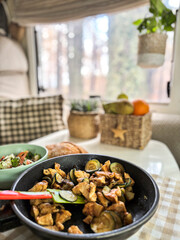 Interior of camper van motorhome with food on the table and gorest view outside the window. Concept of vanlife and travel people vacation lifestyle