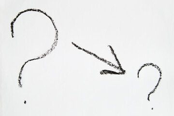 Hand-drawn question mark, boldly marked in black on a white sheet of paper, symbolizing the concept...