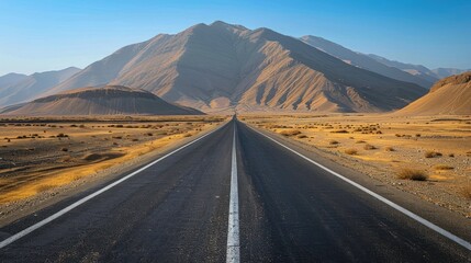 The road winds along empty roads through a barren desert landscape. - obrazy, fototapety, plakaty