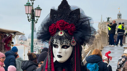 Venice Carnival. People in Venetian carnival masks and costumes on streets of Venice, Italy, Europe...